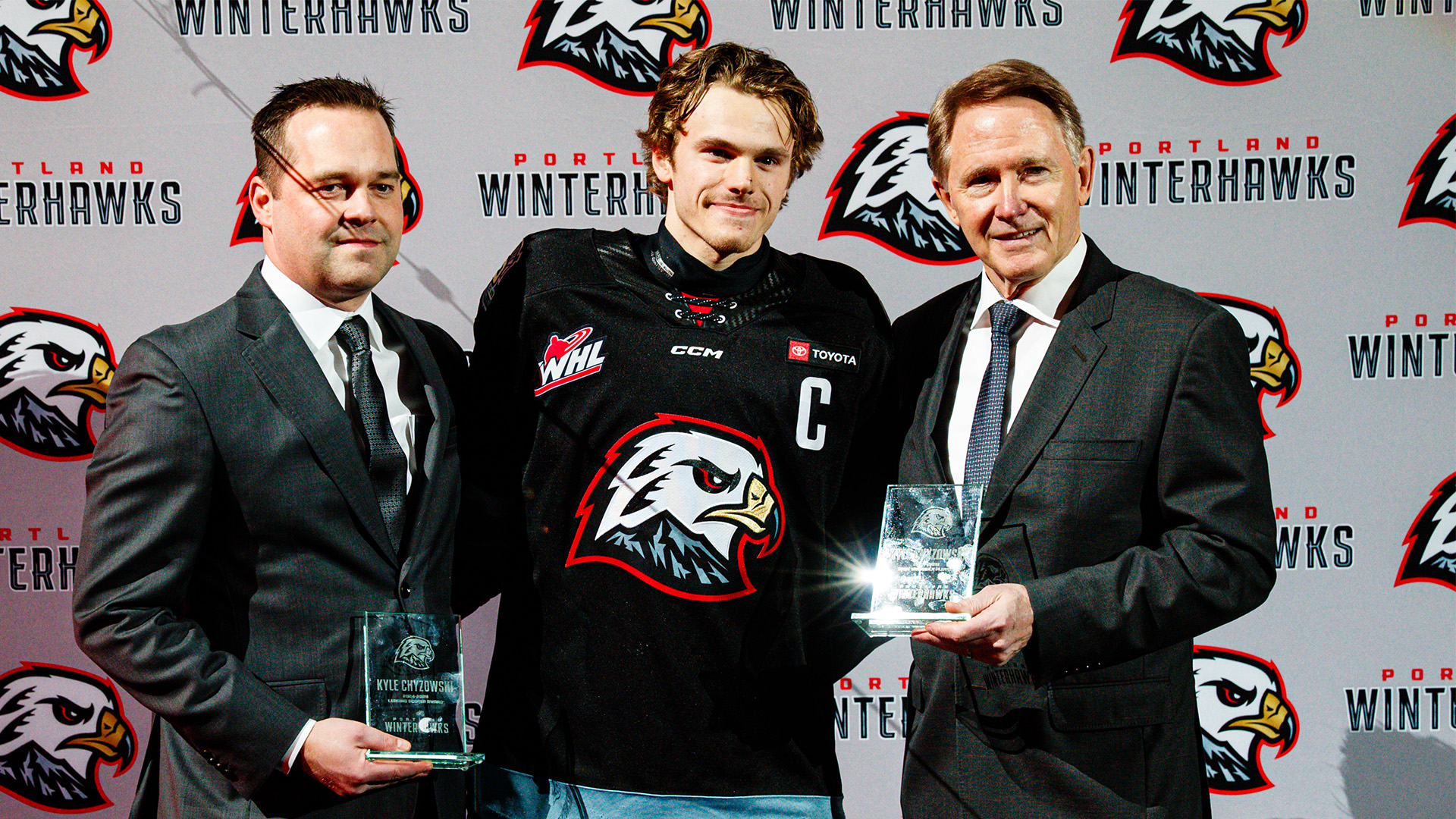 Kyle Gustafson, Kyle Chyzowski, and Mike Johnston holding the Winterhawks Team MVP Award